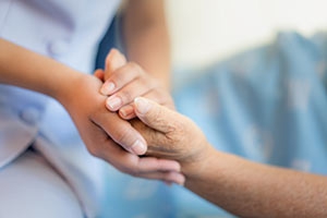 hospitalist holding patient's hands