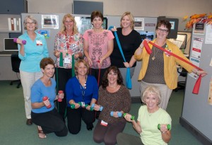 OSF St. Joseph employees take a break to exercise with hand weights and TheraBands
