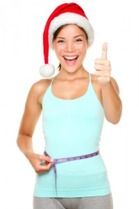 Woman with Santa hat happy about holiday eating tips