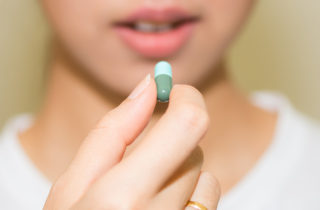 Close-up of woman taking antibiotics