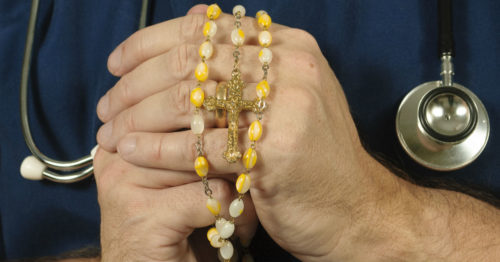 nurse holding rosary