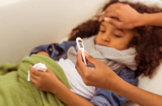 young girl has a fever related to the flu