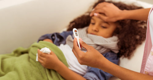 young girl has a fever related to the flu