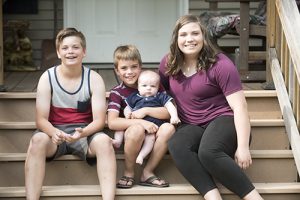 Rapp family kids sit on the porch