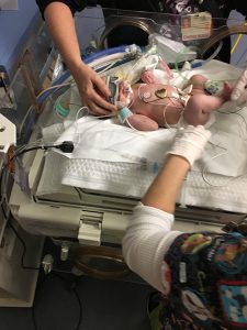 Laura, shortly after arriving to the NICU at OSF HealthCare Children's Hospital of Illinois. The blanket that looks like "bubble wrap" is the cooling blanket she was on for 72 hours.