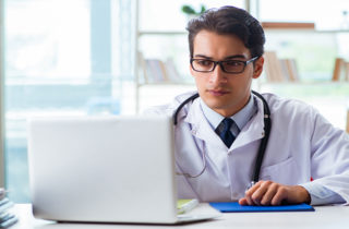 physician helping a patient remotely using a computer