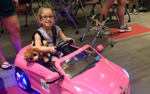 Young girl in a motorized car