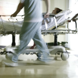 Emergency Department nurses moving a patient on a bed