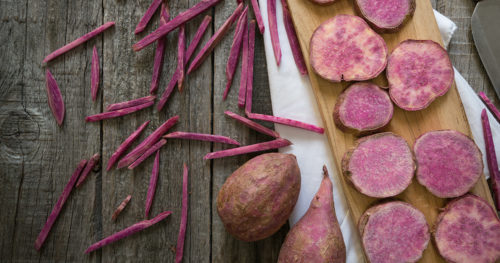 Purple potatoes on a cutting board