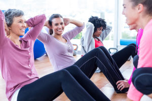 three women doing sit-ups together