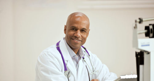 Middle-aged African-American physician in office