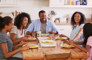 African-American family talking at the breakfast table practicing mindful eating