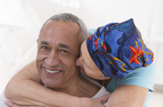 Female hospice patient hugging husband