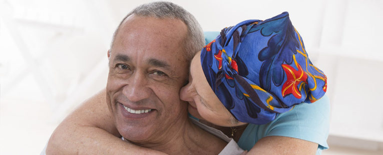 Female hospice patient hugging husband