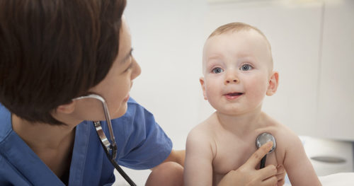nurse taking infant boy's vital signs