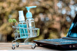 Shopping cart with hand sanitizer and a laptop