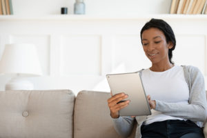 African-American woman using SilverCloud on a tablet.