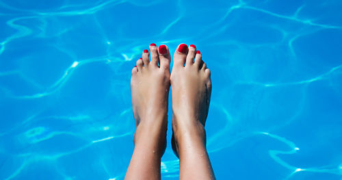 Woman's feet in a pool of water.