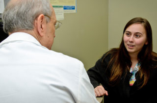 patient talking with a doctor withn an exam room