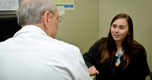 patient talking with a doctor withn an exam room