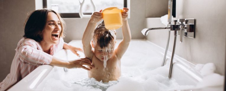 Child taking a bath with his mom