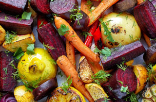 Photo of assorted roasted vegetables including shaved carrots, lemons and assorted root vegetables