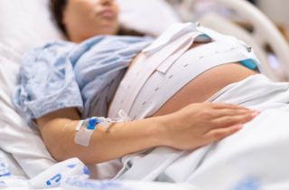 A woman in the hospital is getting induced for labor.