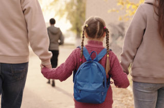 social drivers of health, mom and dad walking child to school