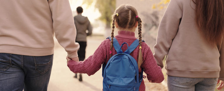 social drivers of health, mom and dad walking child to school