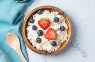 bowl of cottage cheese with strawberries and blueberries