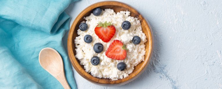 bowl of cottage cheese with strawberries and blueberries