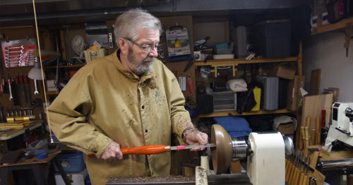 David Alfredson turning a wooden bowl on a lathe