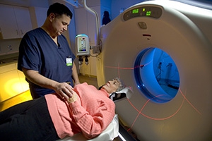 CT scan technician with patient.