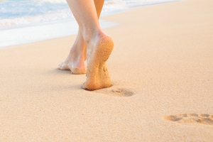 Bare Feet Walking On Beach