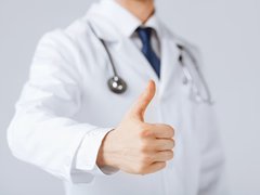 Photo of a doctor with his thumb up.